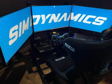 Clubracer in optional black with triple 27" monitors and keyboard tray options. Located in Ongar.