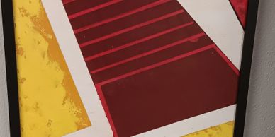 Abstract geometric painting with red, yellow, and white shapes.