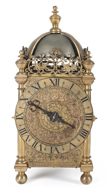 Antique ornate brass clock with Roman numerals.