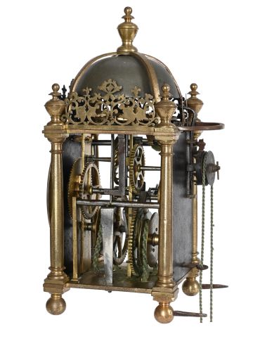 Antique brass and iron clock mechanism with intricate gears.