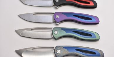 Four folding knives with colorful handles arranged on a white surface.