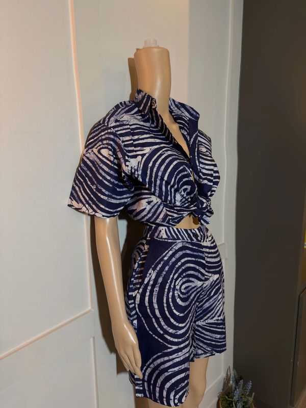 Navy and white tie-dye shirt and shorts set on a mannequin.