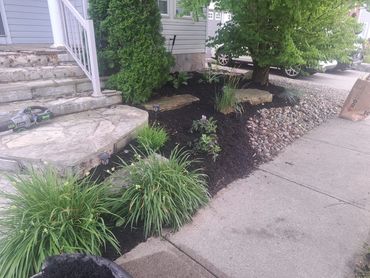 Fresh black mulch around home exterior