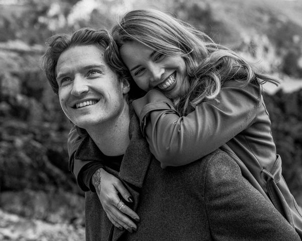 Happy couple sharing a joyful moment outdoors in black and white.