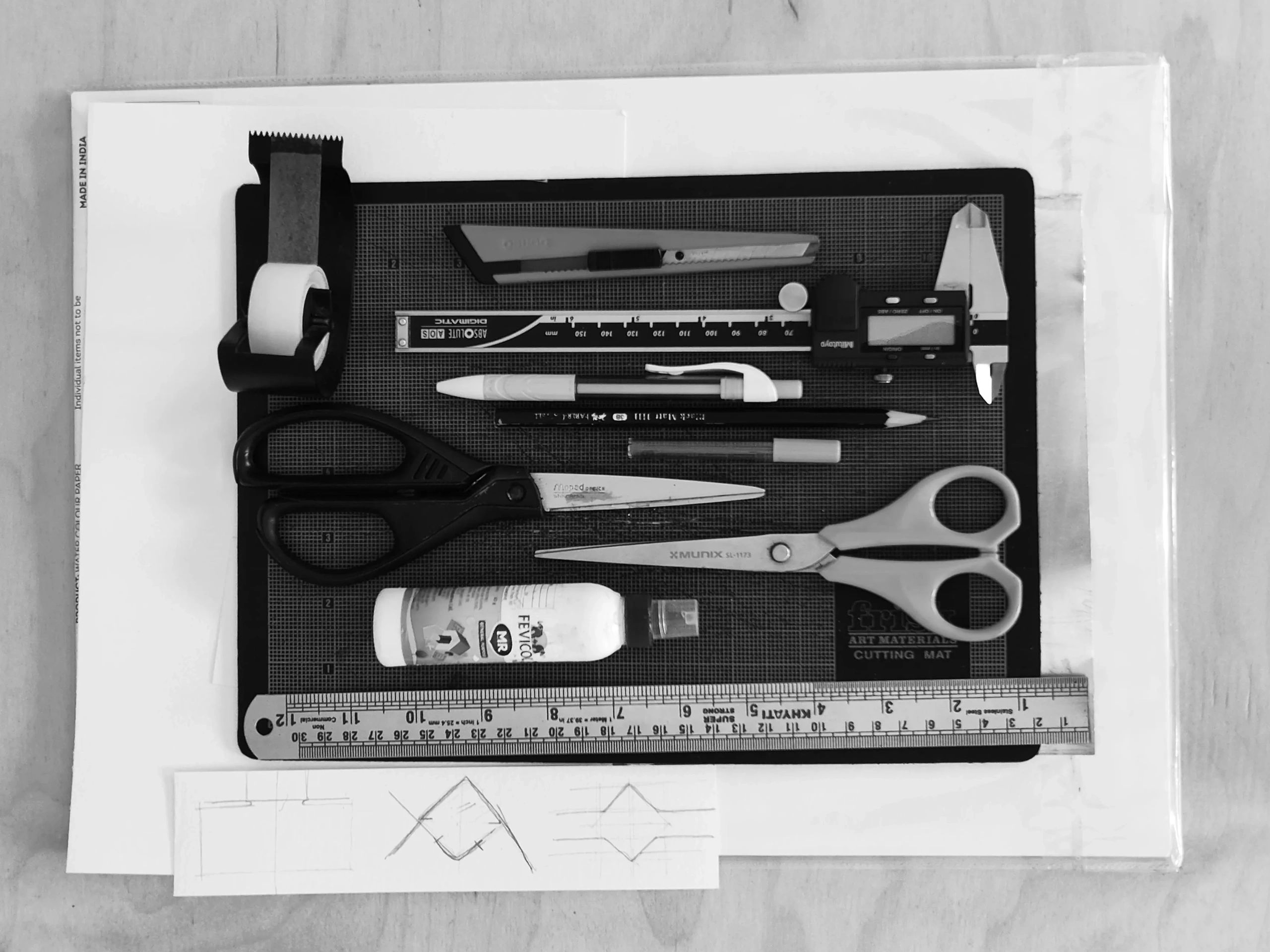 Art and craft tools neatly arranged on a cutting mat.