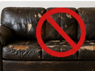 Worn-out leather couch with red prohibition symbol over it.