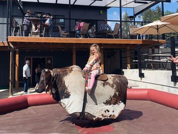 Little girl riding a bucking bull rental
