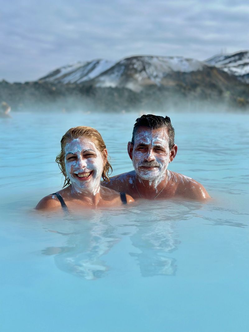ravelers enjoying a relaxing soak in the Blue Lagoon geothermal spa during a private Reykjanes Peninsula tour with 2Go Iceland.