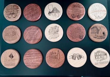 Wooden coasters with San Francisco and beer-themed engravings.