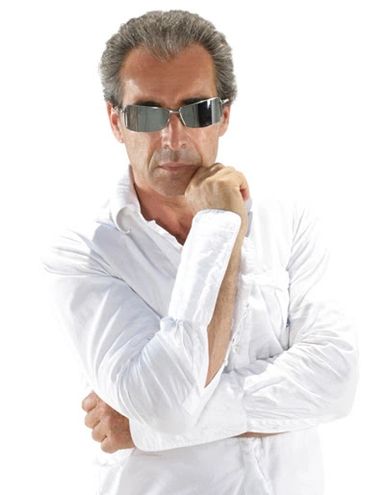 Confident man wearing sunglasses and a white shirt with a thoughtful pose.