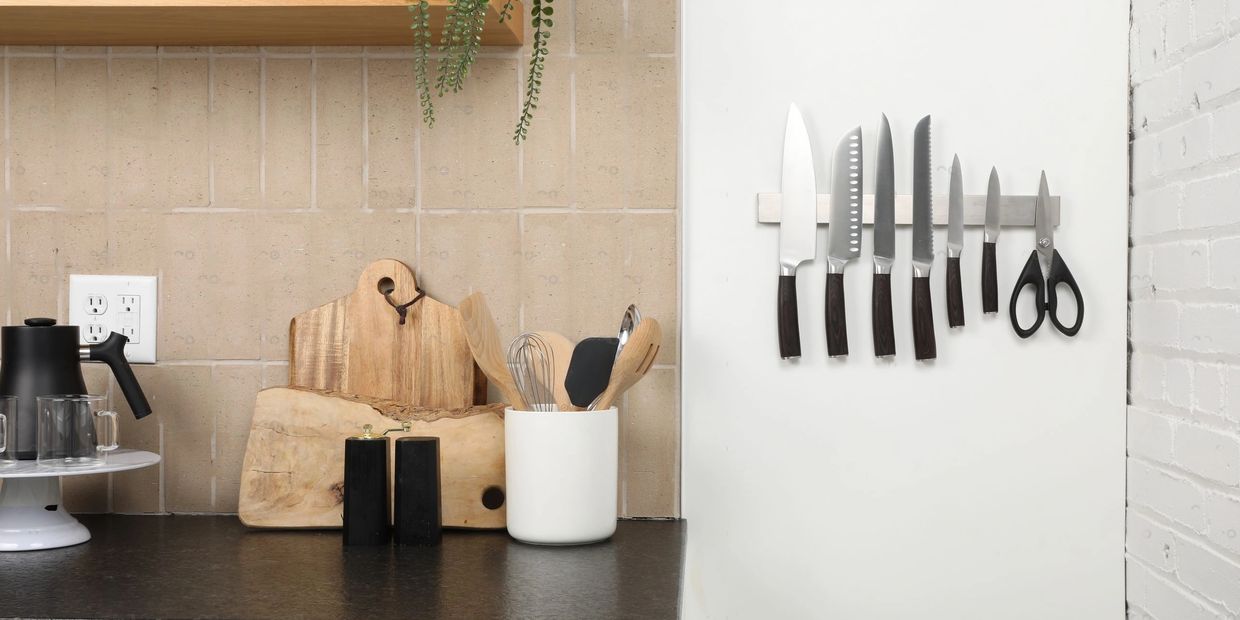 Pampavanna stainless steel magnetic knife holder in kitchen, holding knives on wall