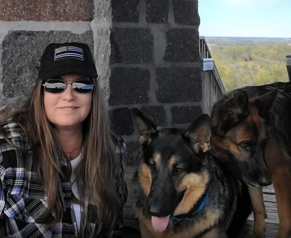Dr. Tami Jo Lieberg with two German Shepherds