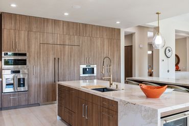 Modern kitchen design with integrated custom cabinets in Alboreto by Cleaf panels in Rancho Mirage