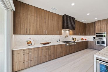 Modern kitchen design with integrated custom cabinets in Alboreto by Cleaf panels in Rancho Mirage
