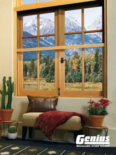 Cozy indoor seating with a stunning mountain view through wooden window frames.