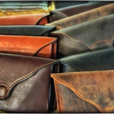 Close-up of leather phone cases in various shades of vintage brown and black.