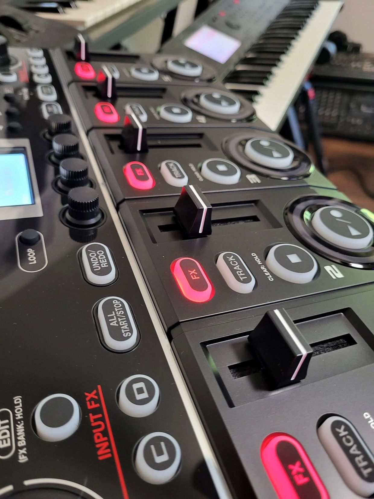 Close-up of a music mixing console with sliders and buttons.