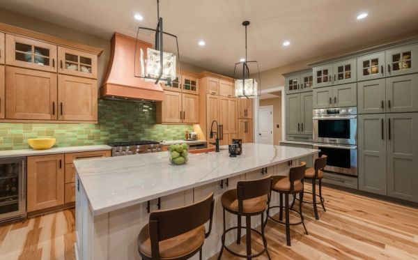 Modern kitchen with wooden cabinets and a marble island.