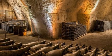 Underground wine cellar with bottles and barrels stored.