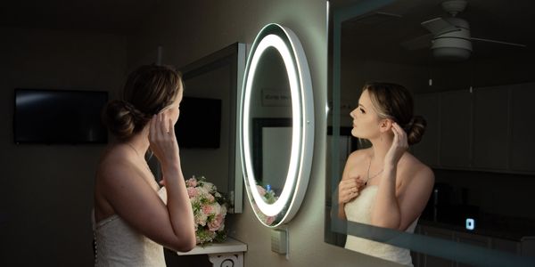 Bride getting ready in the bridal suite with lighted mirror