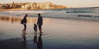 A family of 3 on the beach