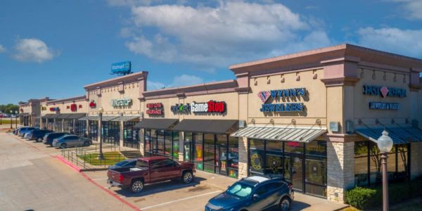 Shopping center with various stores including GameStop and Fantastic Sams.