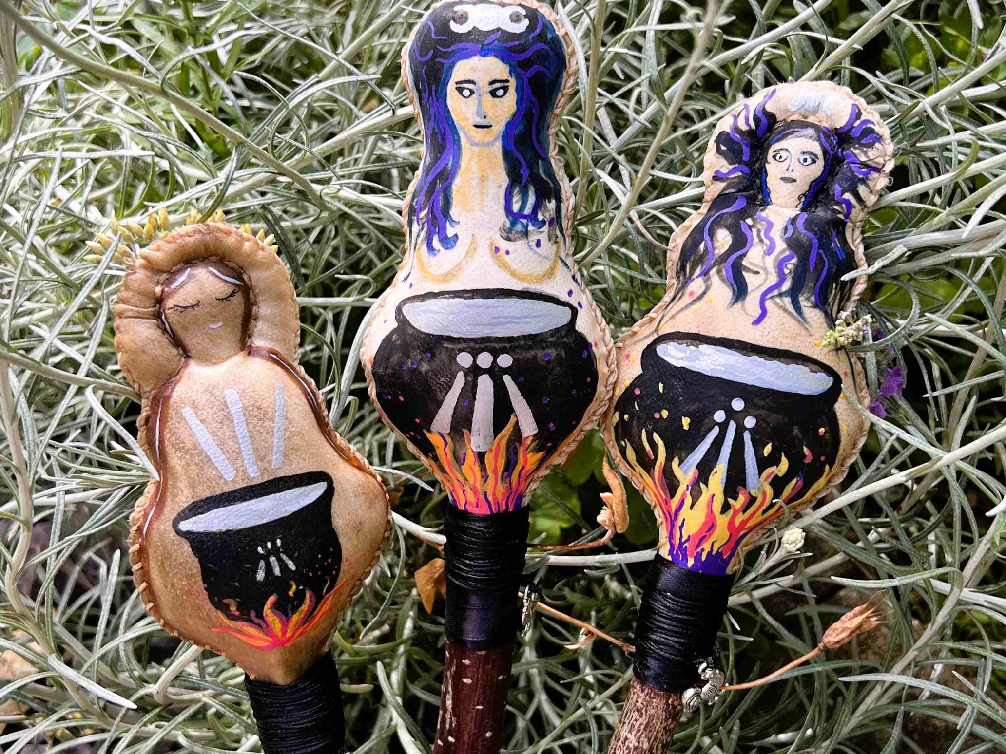 Three different designs of the Cerridwen painted goddess rattle.