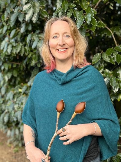 Ruth, SpiritCraft Founder holding a handcrafted Shamanic Rattle