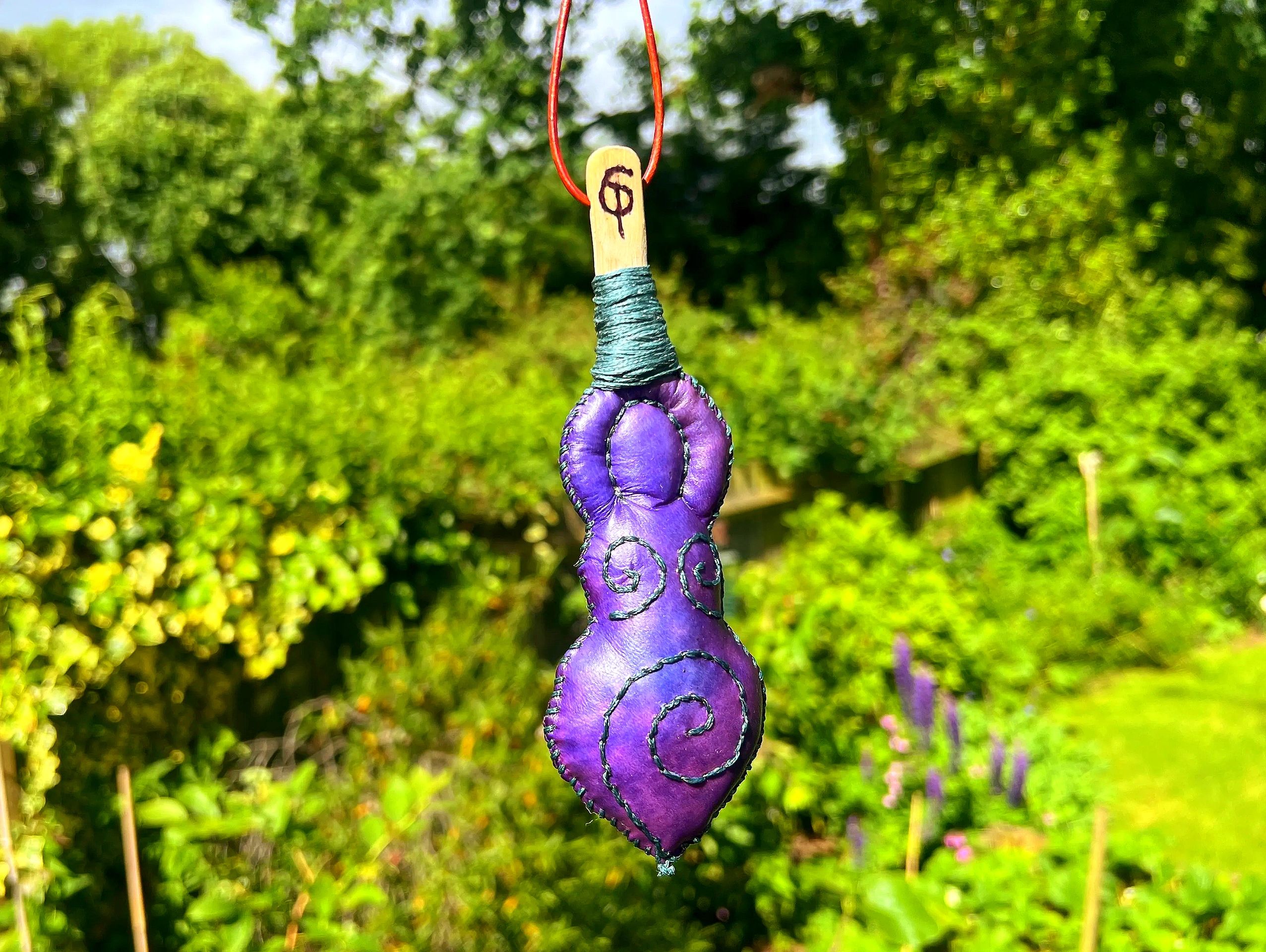 An example of the Dyed Goddess. The colour is a mottled purple/violet base with Teal stitching