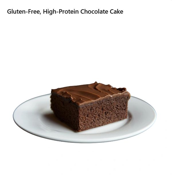 A gluten-free chocolate cake with a glossy glaze, adorned with a dusting of cocoa
