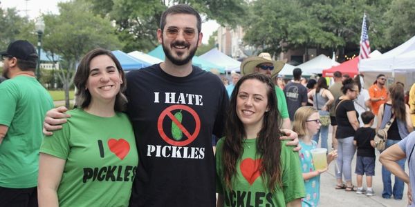 a guy wearing a shirt that says I hate pickles with 2 girls next to him wearing shirts that say I lo