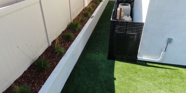 Side yard Landscape design including white small Retaining wall and pool equipment galvanized fence t