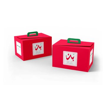 Two red rectangular boxes with green handles and Arabic script on labels.