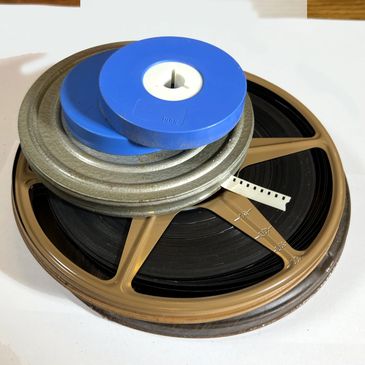 a stack of super-8 film to be transferred by Home Video HQ, 