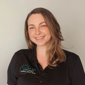 Smiling woman in a black polo shirt.
