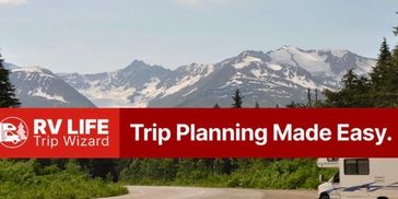 Scenic mountain road with RV planning banner.