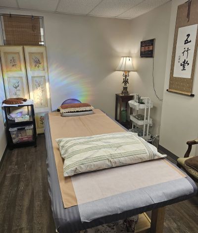 Cozy therapy or massage room with table and warm lighting.