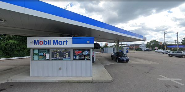 Mobil Mart gas station with a convenience store and multiple fuel pumps.