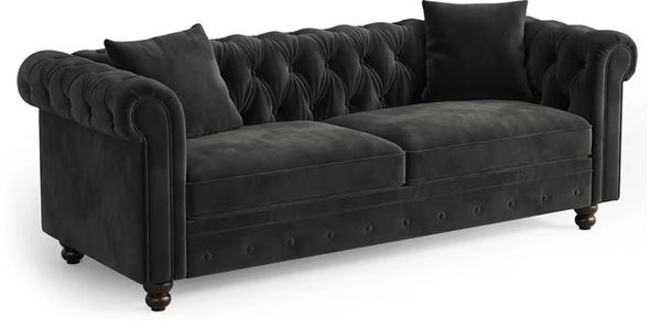 Elegant black velvet tufted sofa with rolled arms and matching cushions.