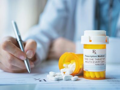 A doctor writing a prescription for medications