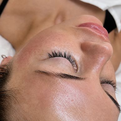 Close-up of a person's face with closed eyes and smooth skin.