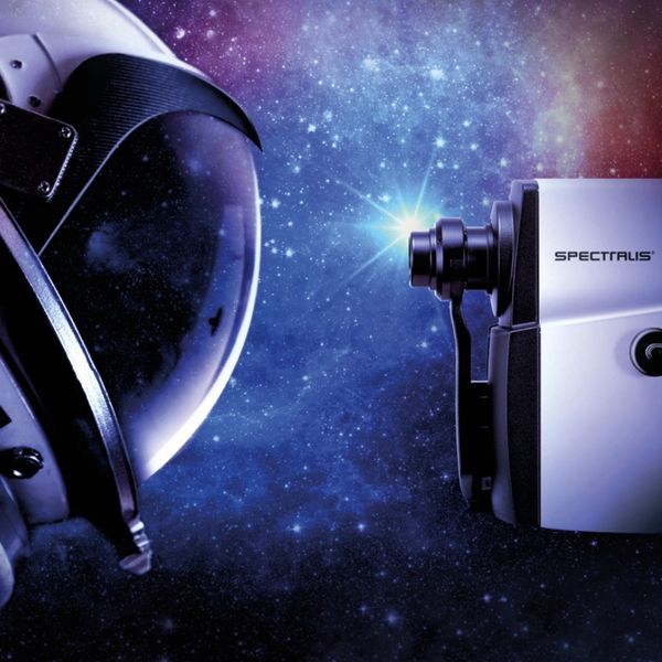 Astronaut helmet and Spectralis device with starry space background and slogan.