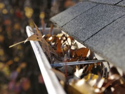 Clogged eavestrough causing water overflow along the roof edge