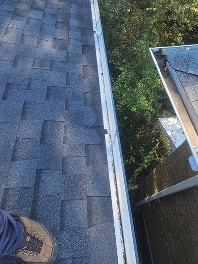 Technician repairing a residential gutter system on a Vaughan home