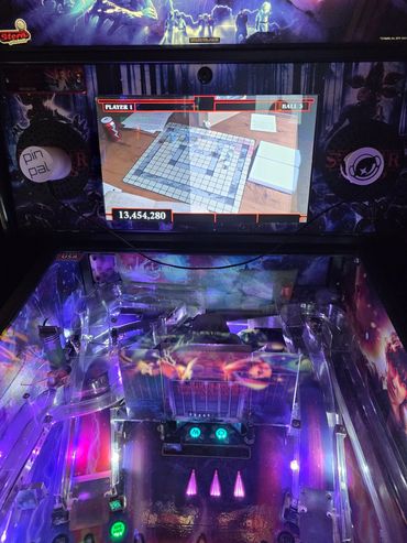 Pinball machine with a digital Scrabble board display.