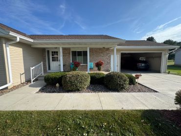Suburban house with a front porch and garage.