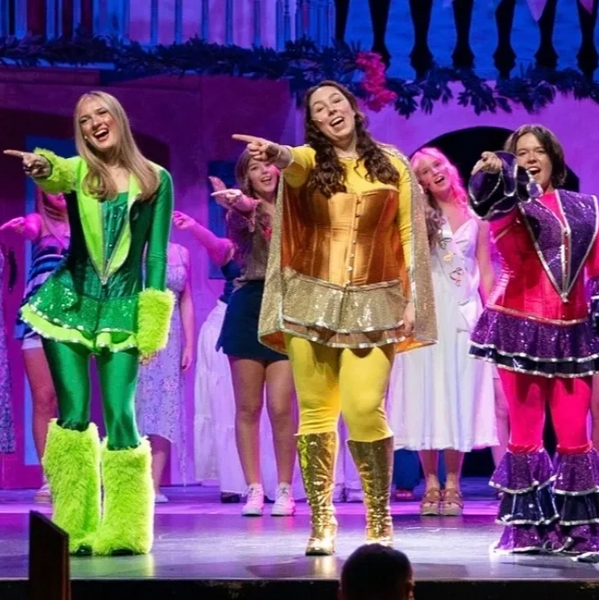 Liv performing as Tanya in "Mamma Mia!" singing "Super Trouper" with her fellow Dynamos.