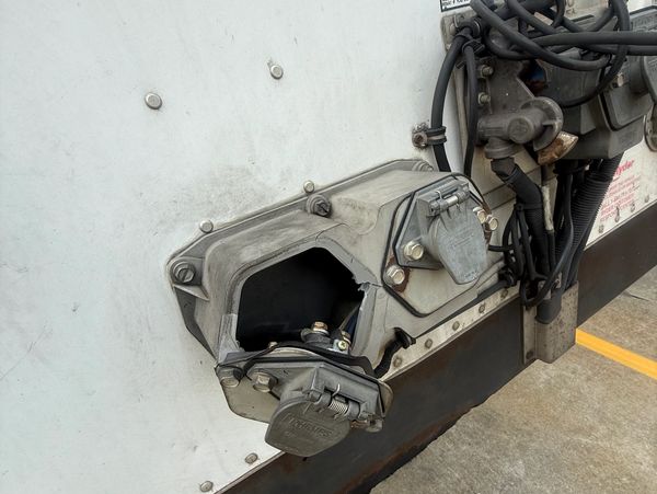 Damaged electrical connection box on a trailer.