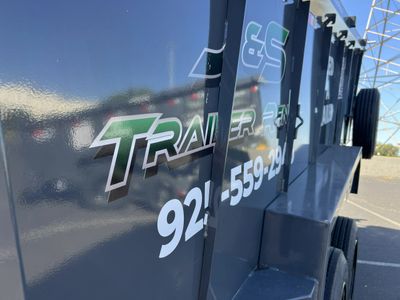 Close-up of a trailer with partial phone number and logo visible.