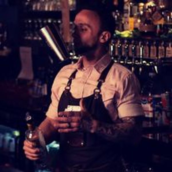 Bartender flipping a tin, making a cocktail